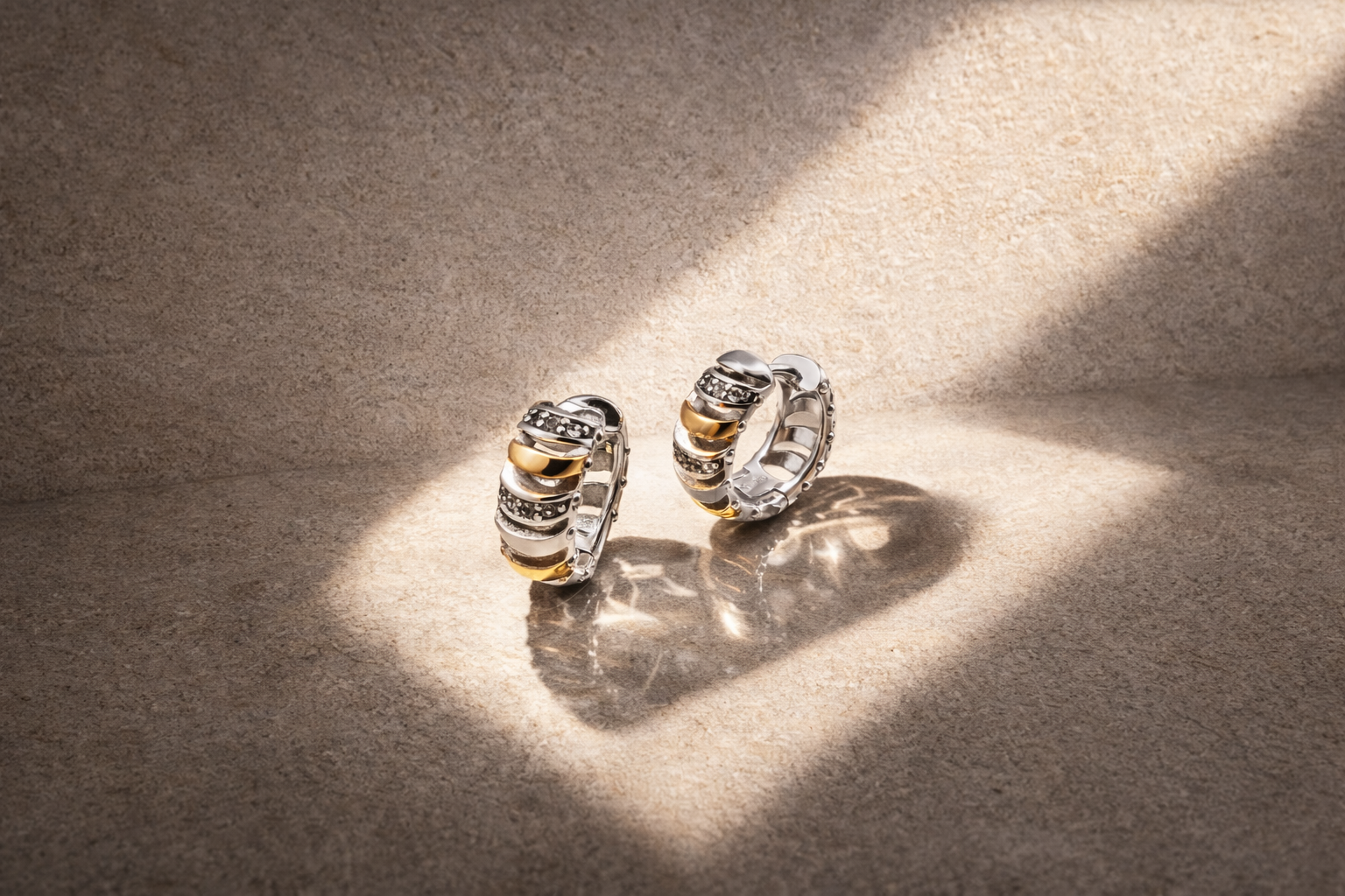 Gold and silver huggie earrings featured in a guide explaining how to clean earrings safely at home