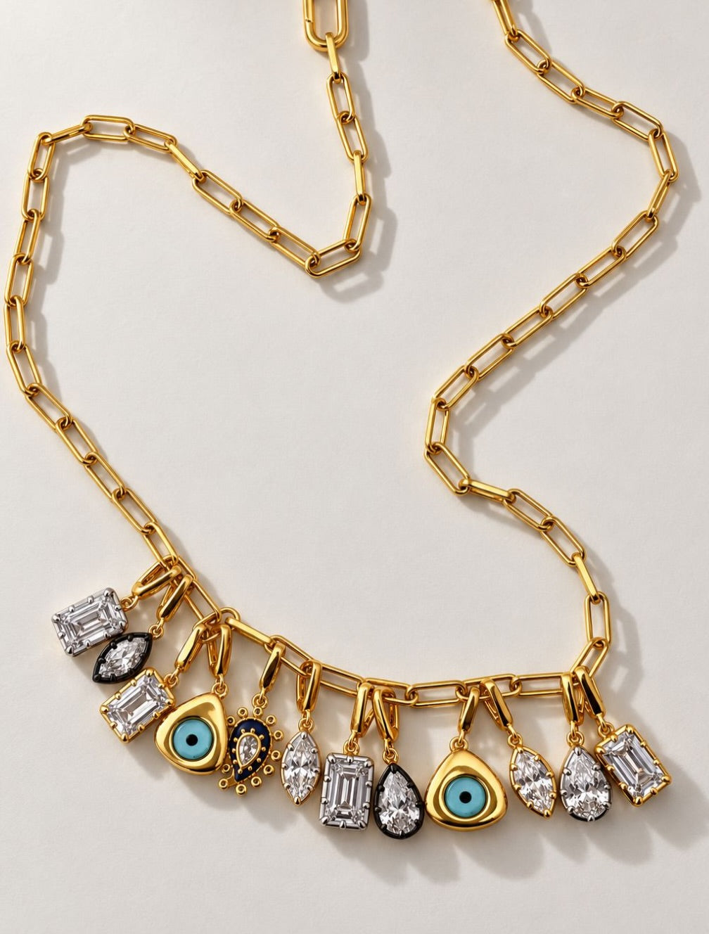Interchangeable charm necklace on a gold paperclip chain