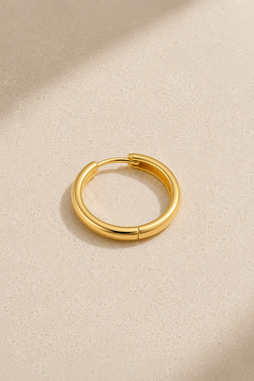 Polished gold hoop huggie earring for lobe and conch piercings standing upright
