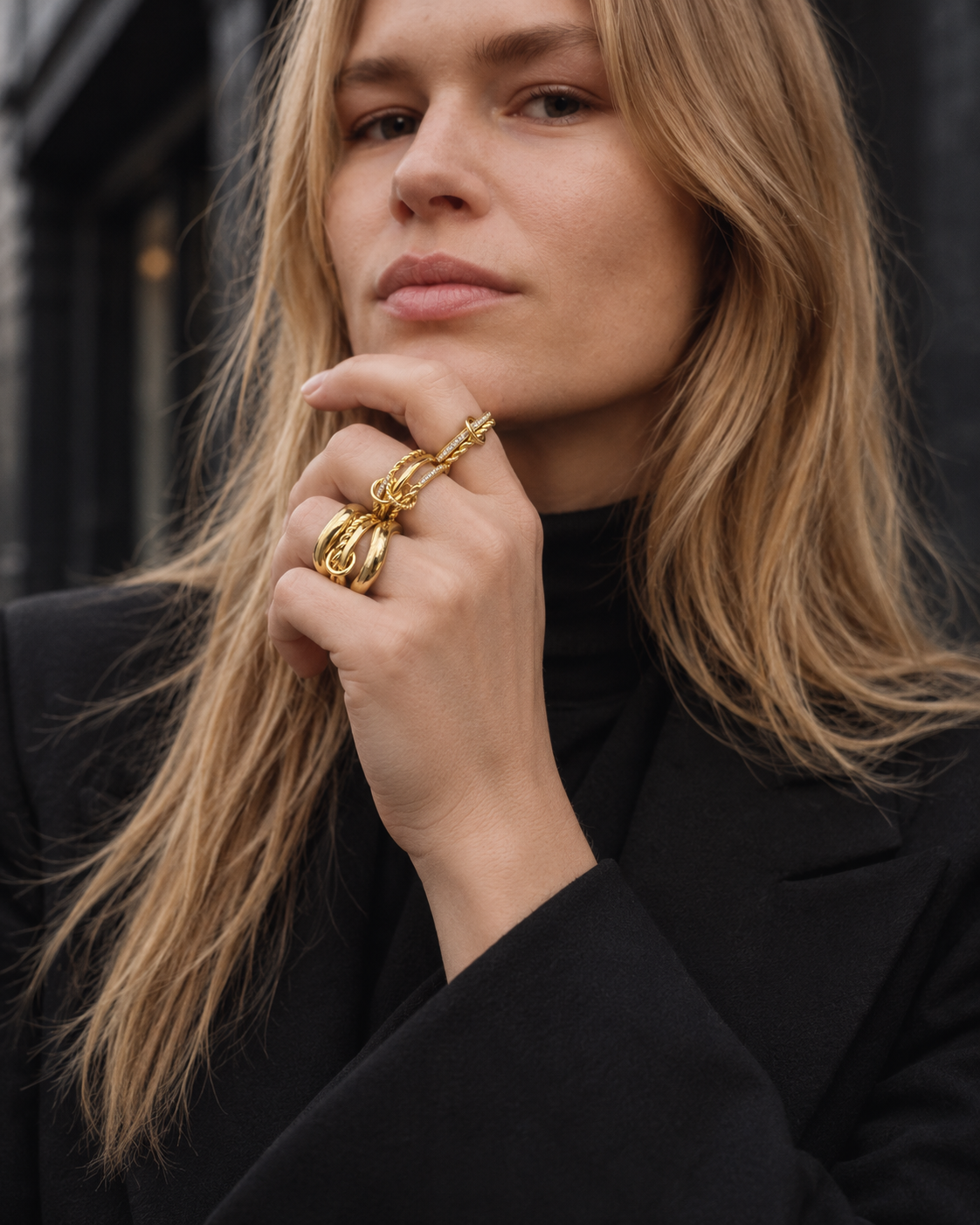 All-gold ring stack by Galleria Armadoro styled with a total-black outfit for a polished sculptural jewellery look.