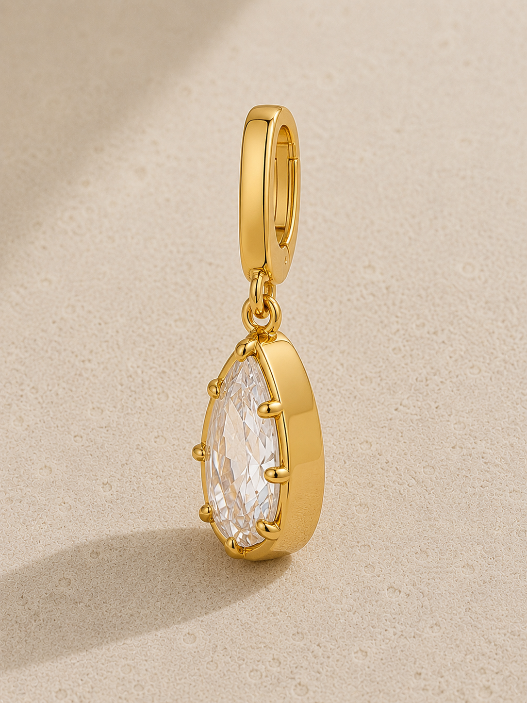 Vittoria gold crystal hook charm hanging from signature clasp