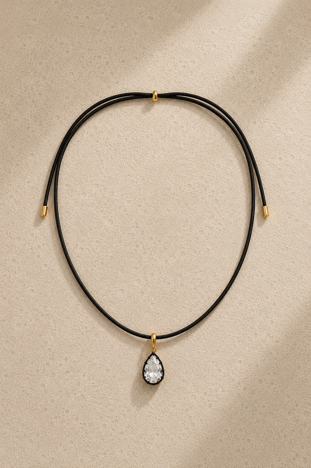 The Adjustable Gold Cord Necklace styled with the Vittoria Gold & Black Rhodium Hook Charm. The ultimate modern summer jewellery statement.
