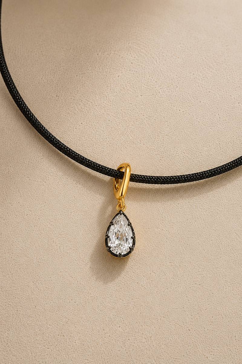 The Adjustable Gold Cord Necklace styled with the Vittoria Gold & Black Rhodium Hook Charm. The ultimate modern summer jewellery statement.