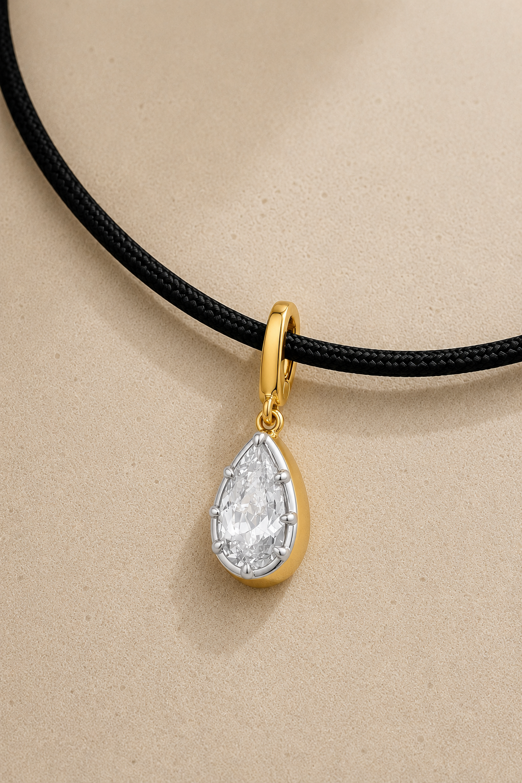 Close-up of silver and gold Vittoria crystal charm hanging on adjustable black cord necklace