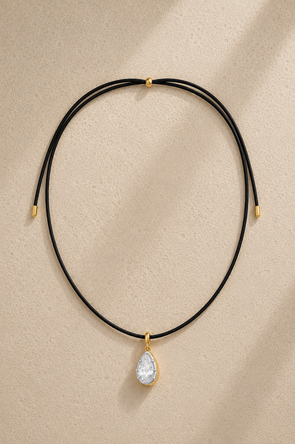 Black adjustable cord necklace with mixed-metal Vittoria crystal charm on beige studio background