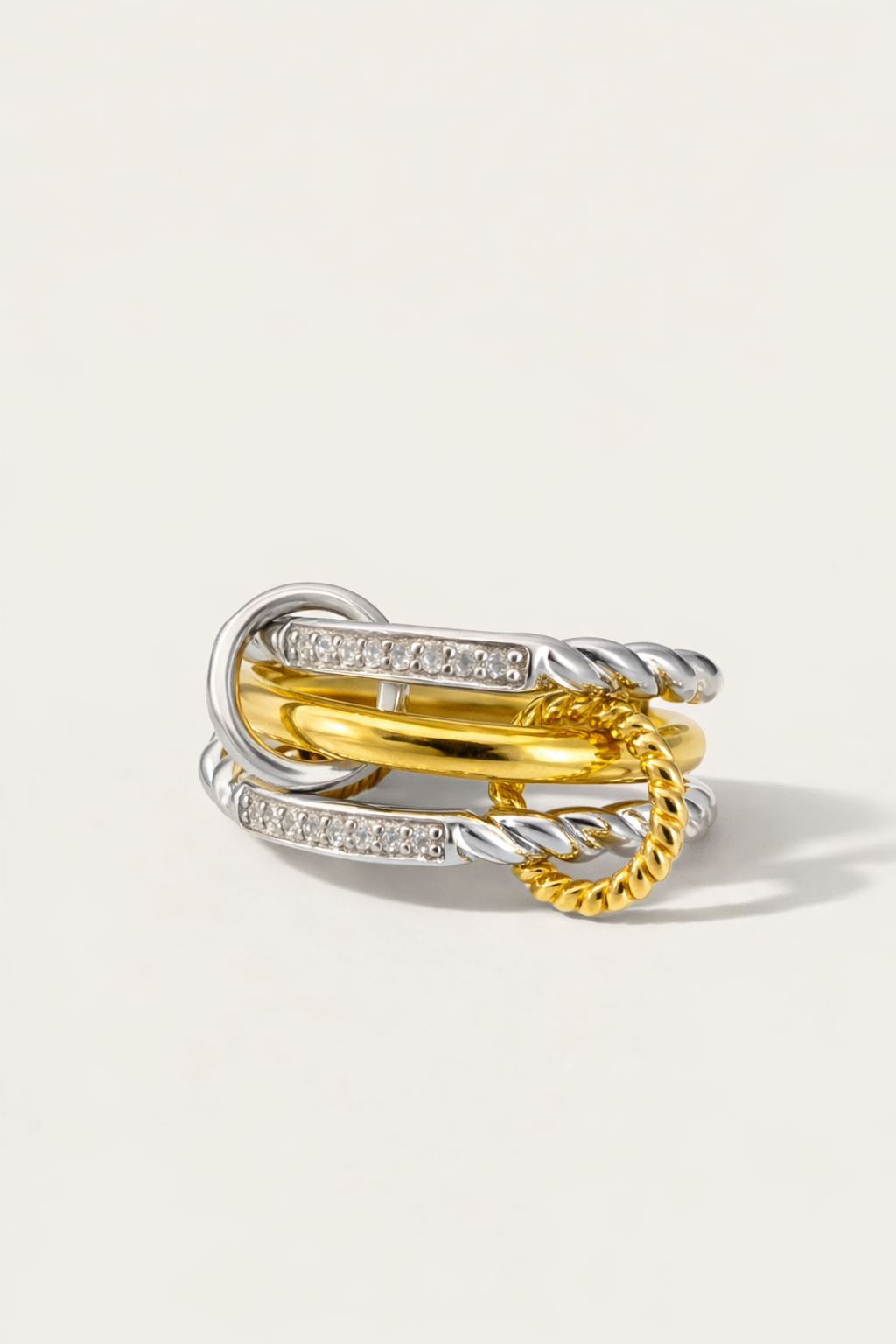 Three gold rings stacked on a light gray background