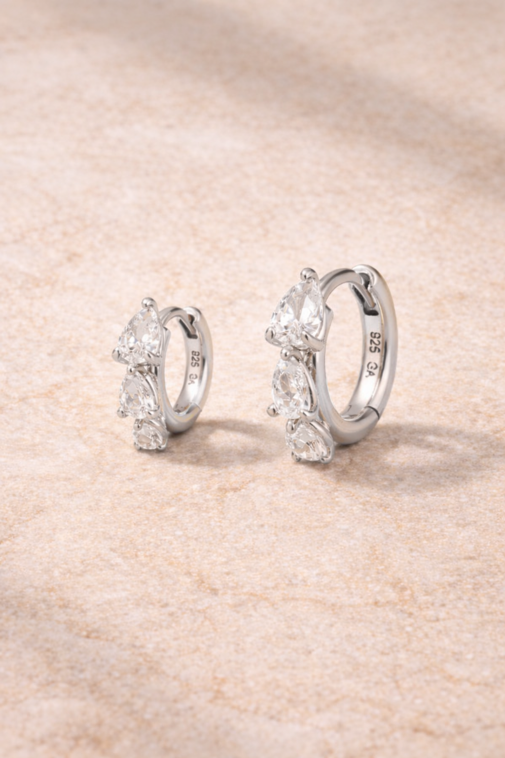 Double ear piercing sterling silver huggie set with 6.5mm and 8.5mm cascade graduated pear cut cubic zirconia