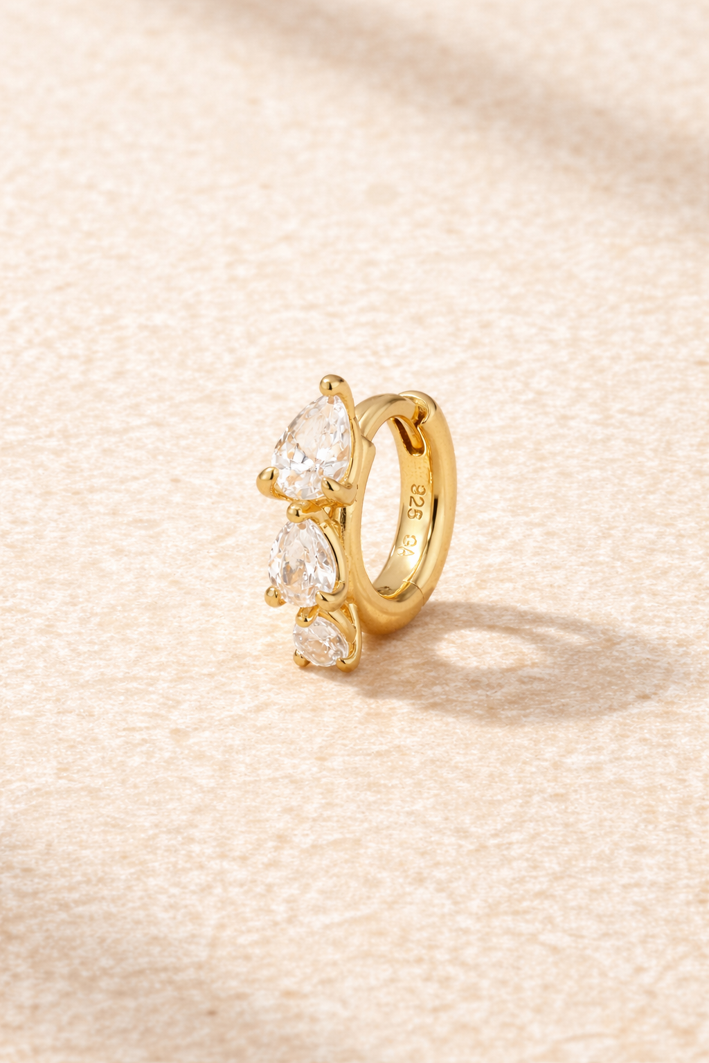 “Cascade Huggie gold 6.5 mm with graduated pear-cut white cubic zirconia”