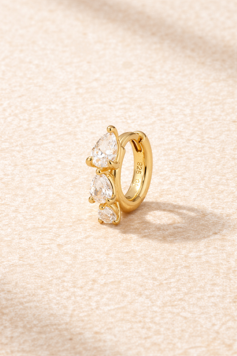 “Cascade Huggie gold 6.5 mm with graduated pear-cut white cubic zirconia”