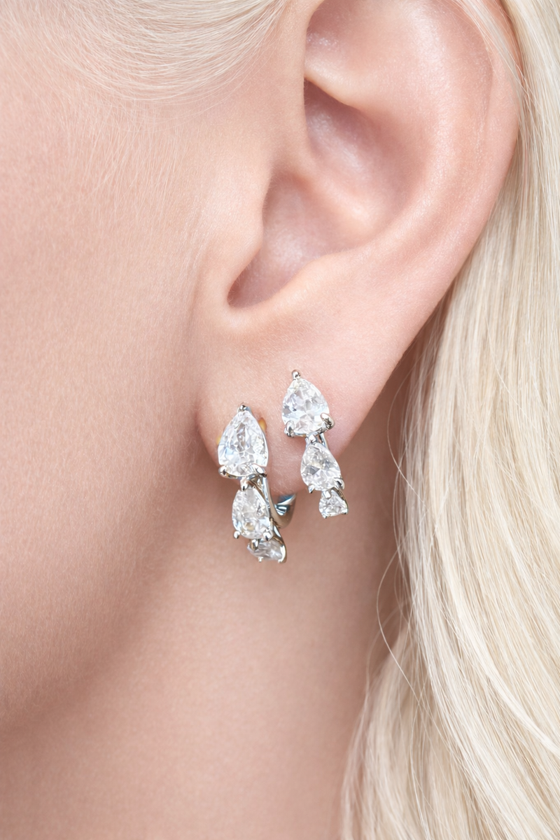 Two earrings in one ear styling with cascade silver huggies for second ear piercings and modern ear stacks