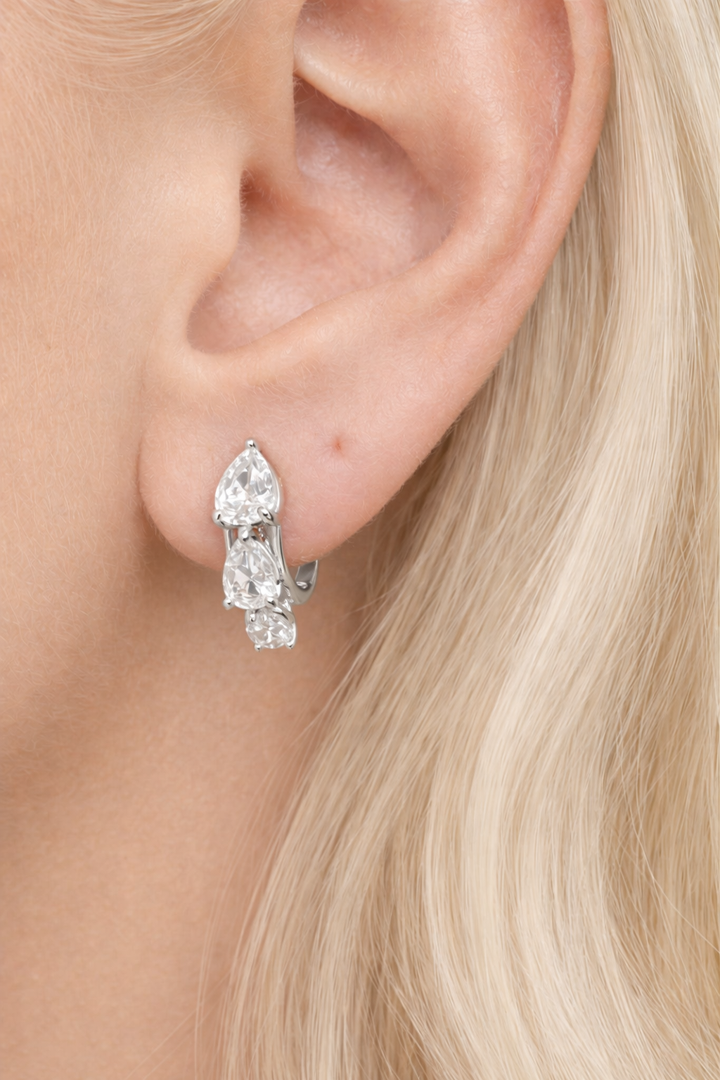 “Cascade silver huggie worn on ear, first and second lobe piercing”
