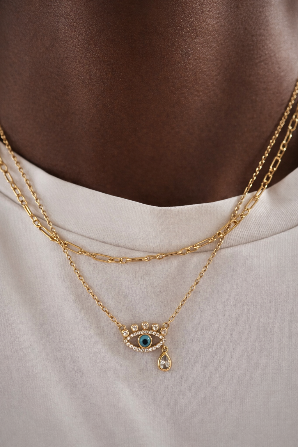Catalina gold chain layered with evil eye necklace on model