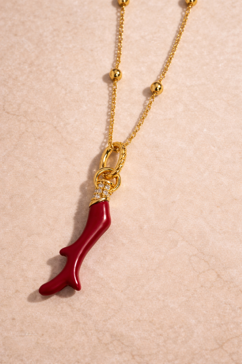 Close-up of Speira red coral gold vermeil charm in 925 sterling silver with 18ct gold plating and white CZ pavé detailing