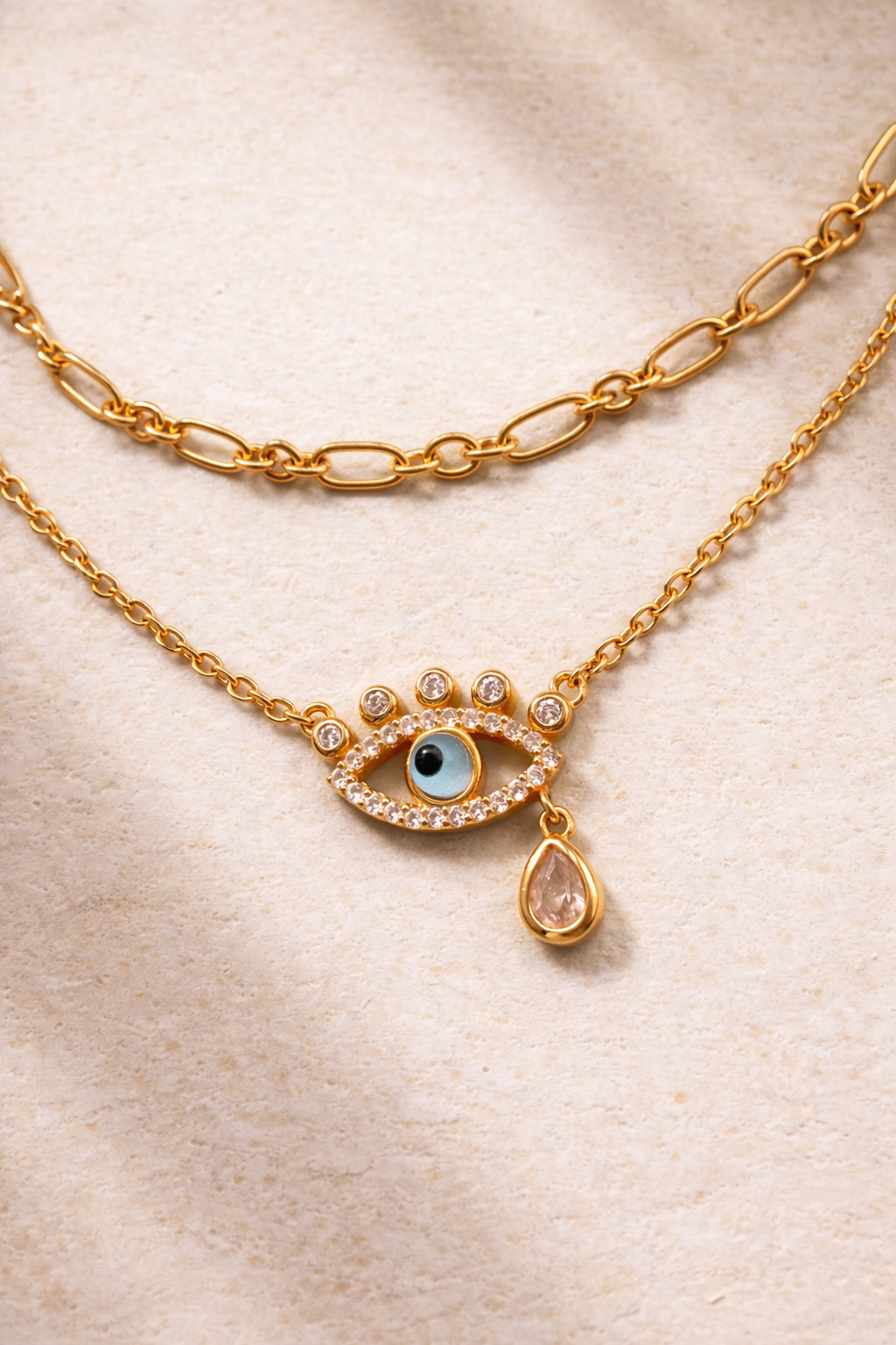 Dainty gold chain and evil eye necklace styled together