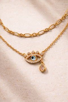 Dainty gold chain and evil eye necklace styled together