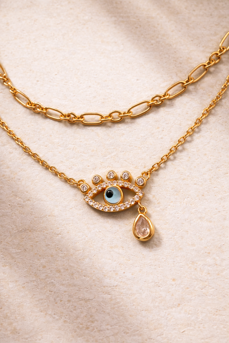 Dainty gold chain and evil eye necklace styled together