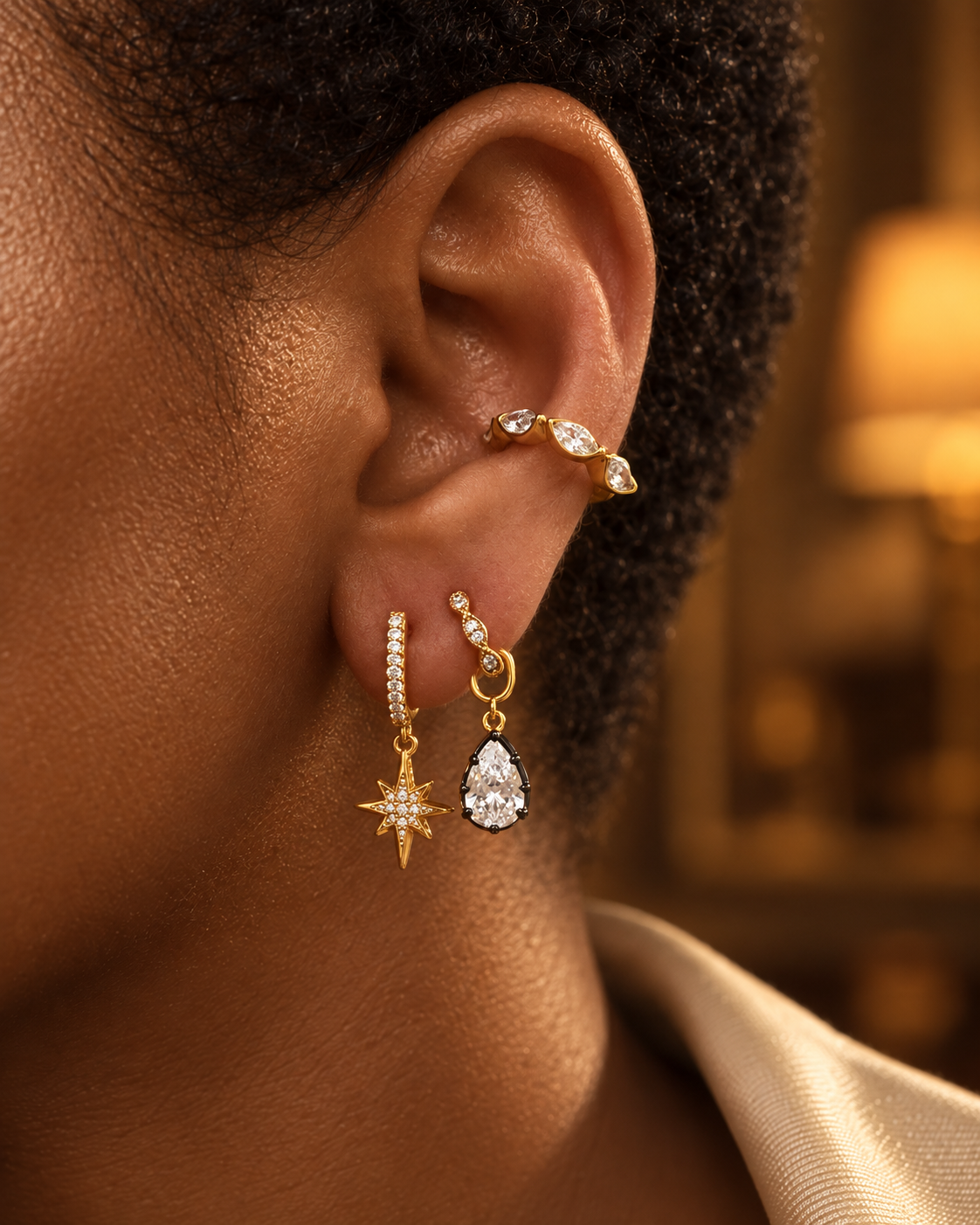 Second ear piercing idea by Galleria Armadoro featuring a gold star charm huggie, black rhodium Vittoria teardrop charm and marquise ear cuff.