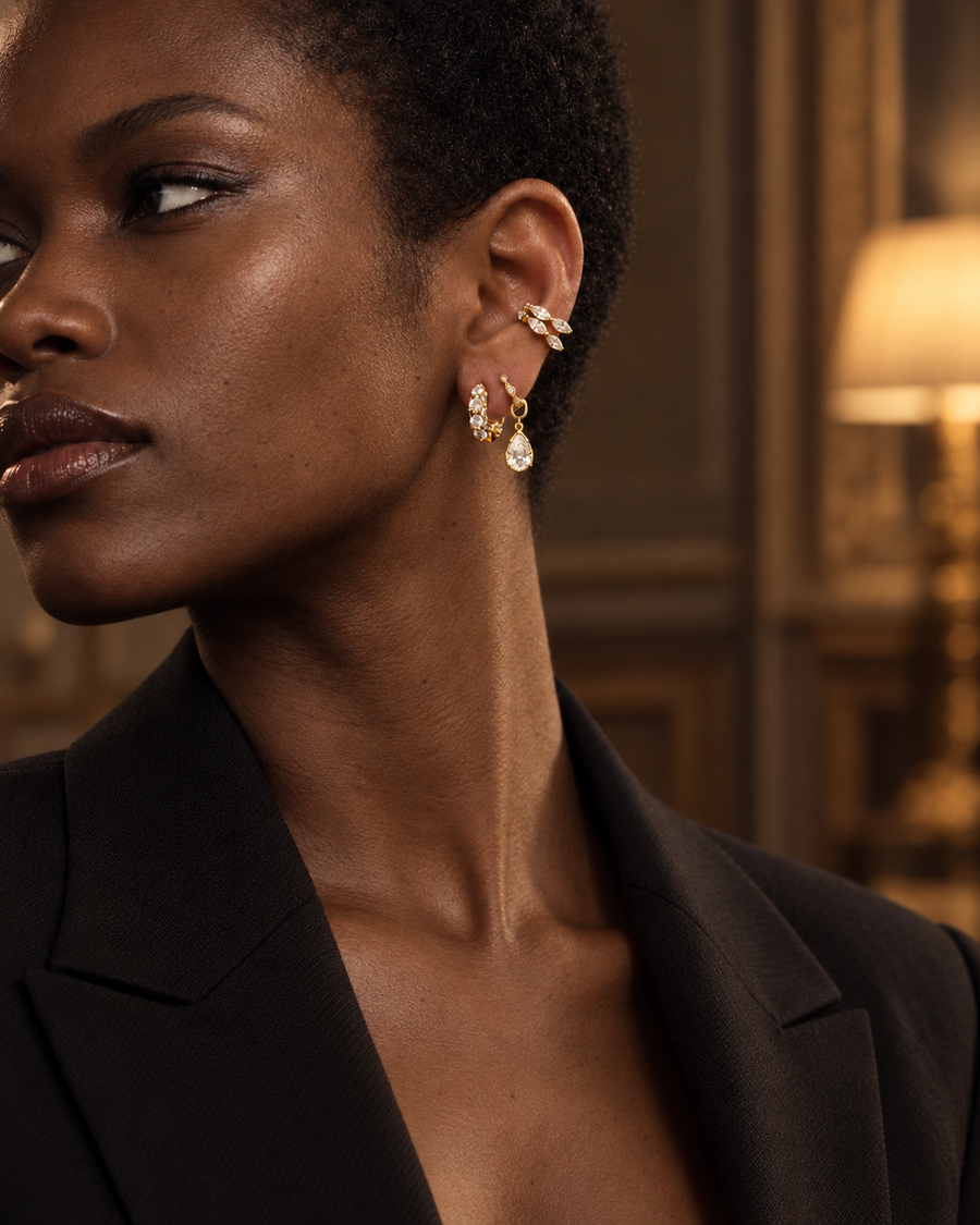Second ear piercing idea by Galleria Armadoro featuring an all-round pavé oval huggie, Mini Gala and black rhodium teardrop charm with ear cuffs