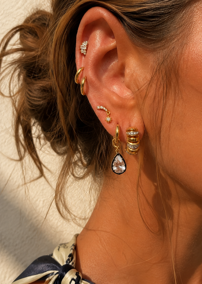 Gold and white rhodium ear stack styled by Galleria Armadoro with huggies, studs and a teardrop earring