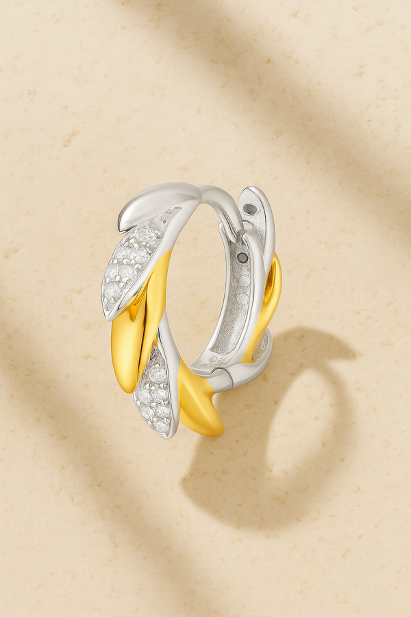 Elara Two-Tone Huggie Earring in 18ct gold and white rhodium plated sterling silver with sculptural design by Galleria Armadoro.
