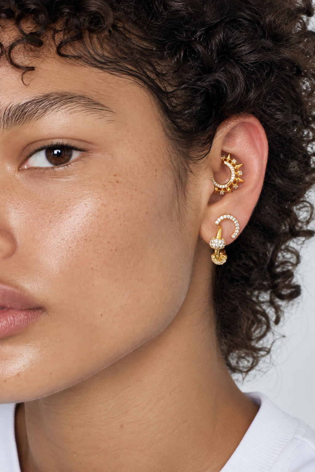 Minimal gold ear stack by Galleria Armadoro featuring Zeina on the first lobe and Spina styled on the daith for a high-impact two-piercing look.
