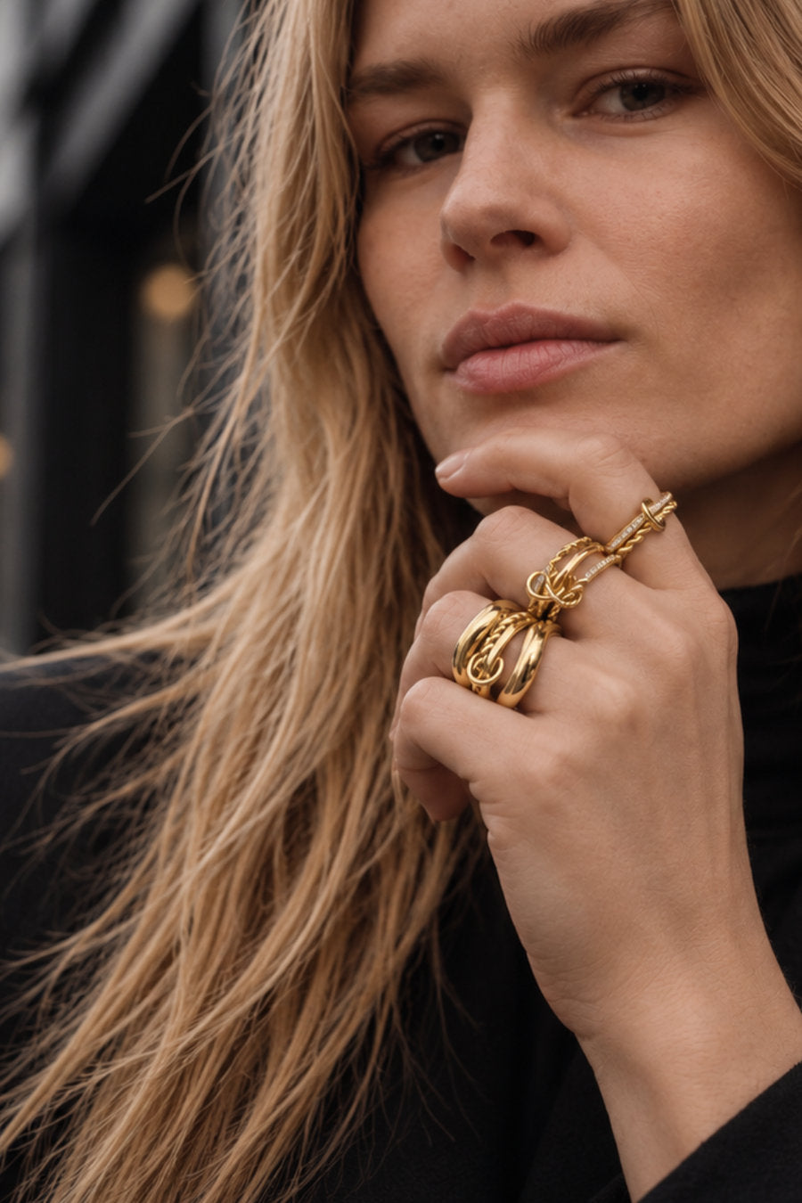 Galleria Armadoro gold rings stacked on a model's hand
