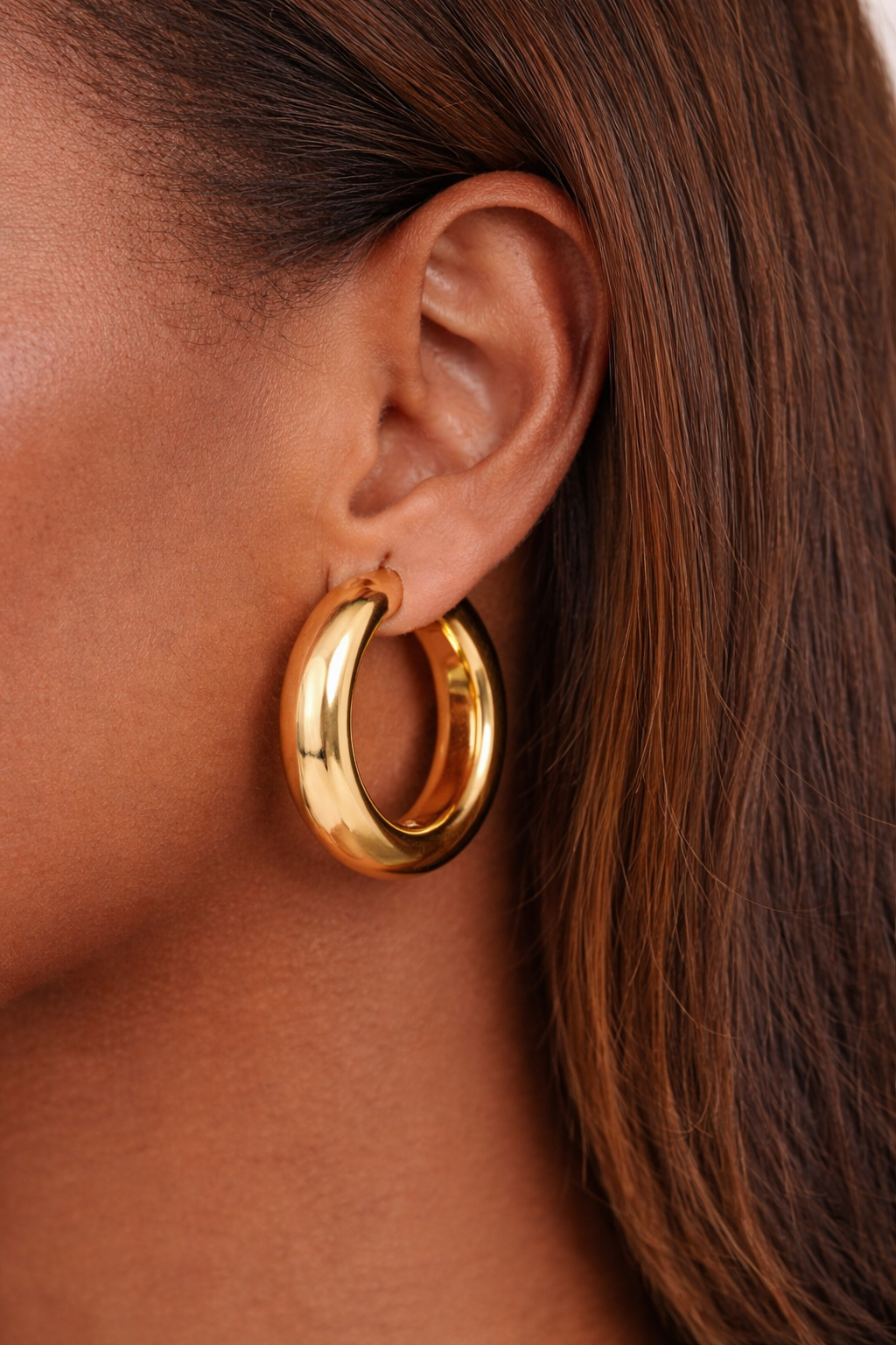 bold gold hoop earrings worn on ear chunky everyday styling
