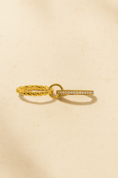 Close-up of Livia double band pavé gold ring on warm stone background – Galleria Armadoro stacking ring.