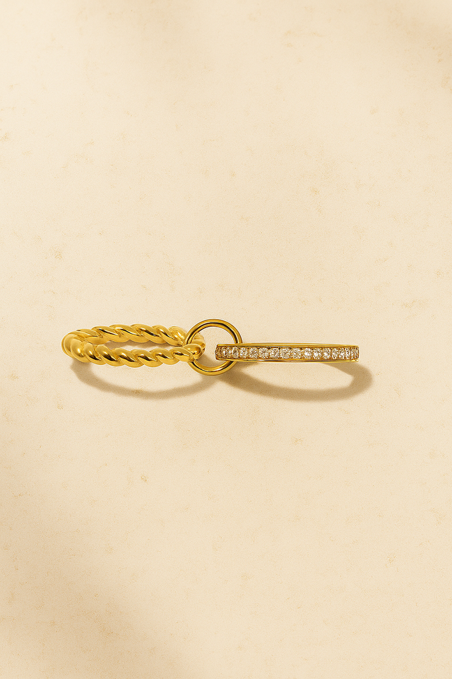 Close-up of Livia double band pavé gold ring on warm stone background – Galleria Armadoro stacking ring.