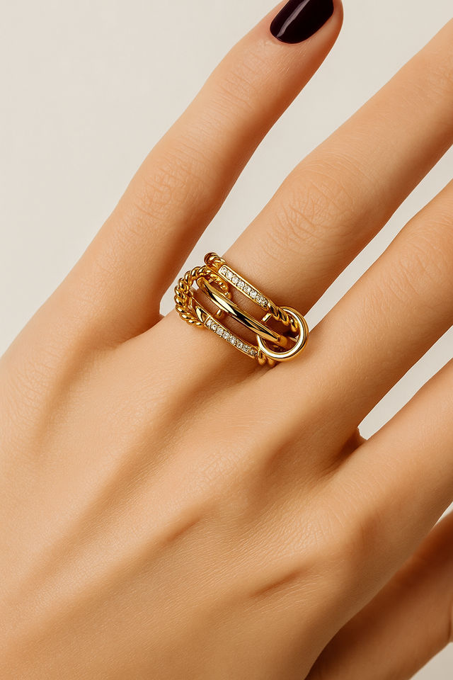 Editorial shot of Carmella Speira ring on finger with deep burgundy nail polish.