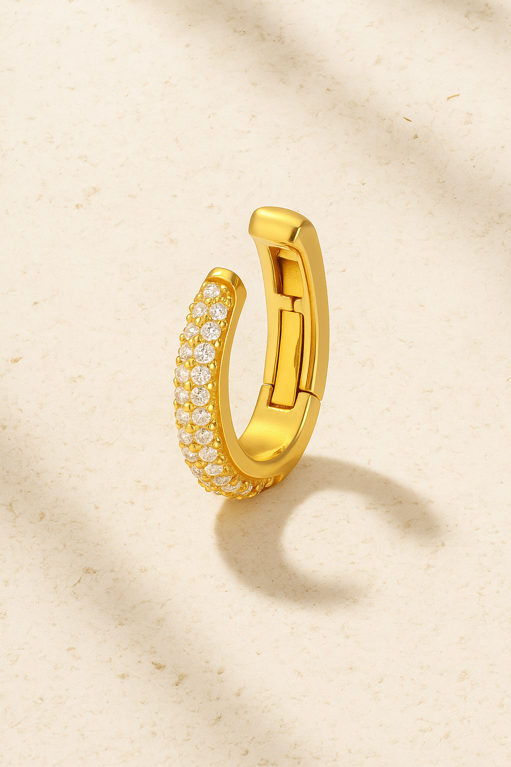 Gold Mina Pavé hinged ear cuff standing open, showing hinge mechanism and cubic zirconia stones.