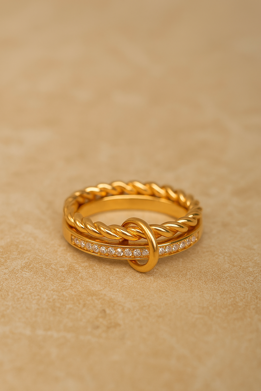 Close-up of Livia double band pavé ring on stone background, showing twisted rope and pavé bar.