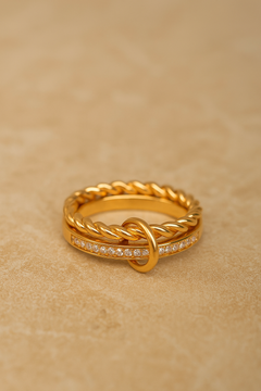 Close-up of Livia double band pavé ring on stone background, showing twisted rope and pavé bar.