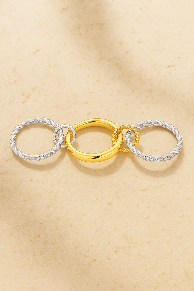 Close-up of two-tone Carmella Speira ring with interlinked gold and silver bands.