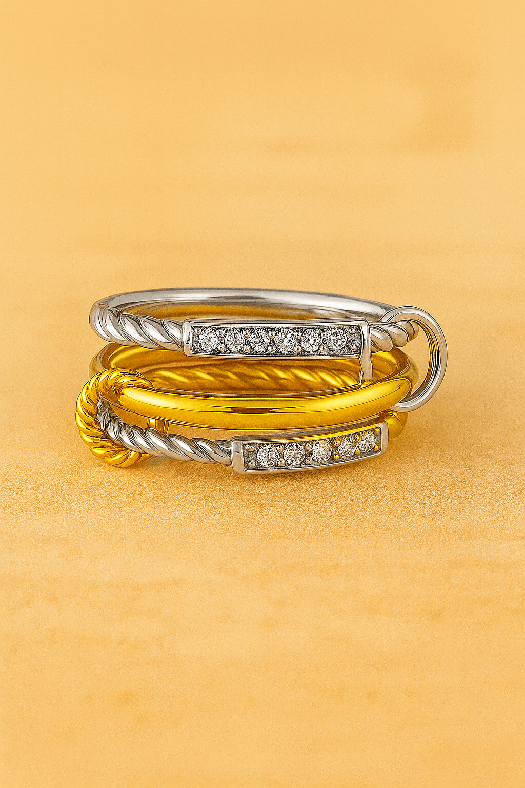 Two-tone iteration of the Carmella Speira rings laid flat, showing silver rope and gold polished bands.