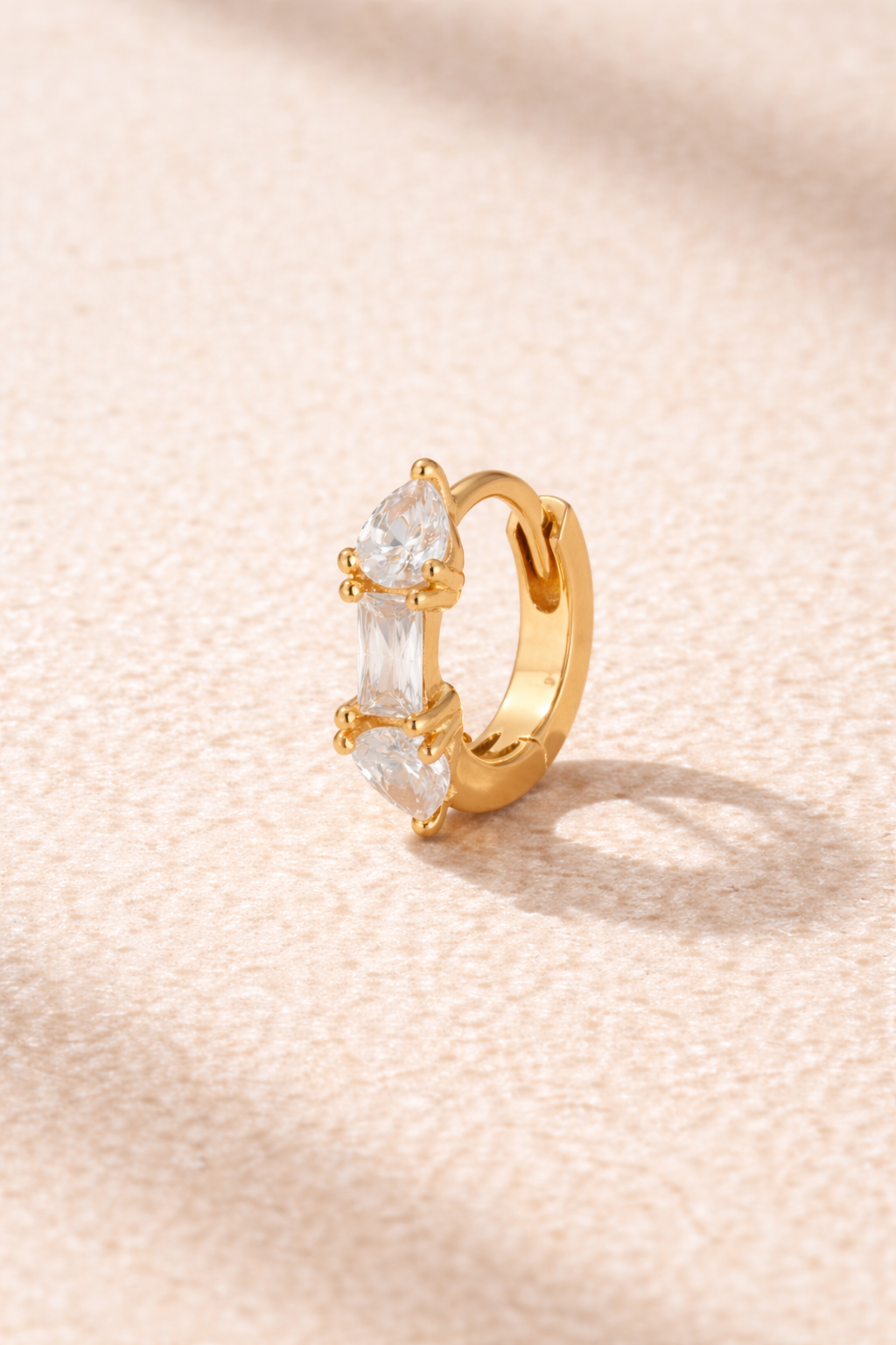 “Ivy Mini Hoop gold 6.5 mm huggie with white cubic zirconia stones”