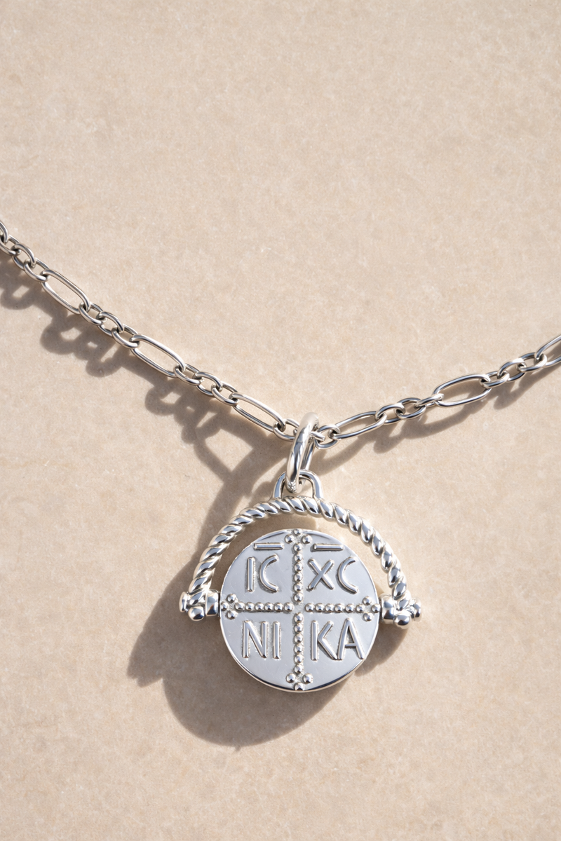 Konstantinato Greek coin charm necklace on Catalina sterling silver chain photographed in studio lighting