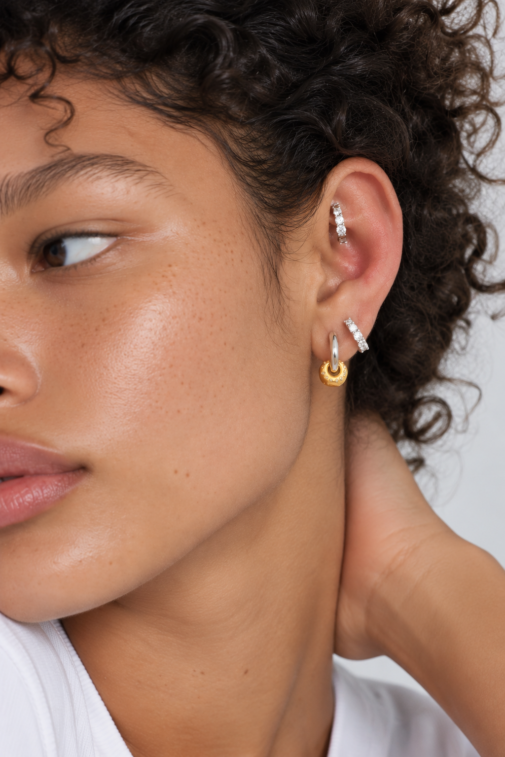 Mixed-metal ear stack by Galleria Armadoro featuring Kora on the first lobe and Mini Gala 6.5 mm on the second lobe and styled on the rook.
