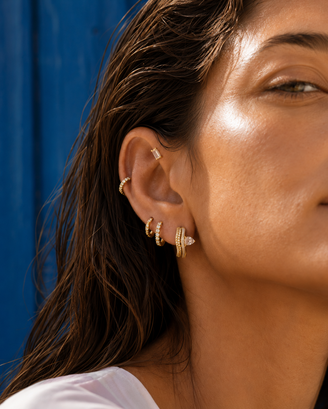 Gold ear stack styled by Galleria Armadoro with a statement Maura hoop, pavé huggies and a forward helix stud.