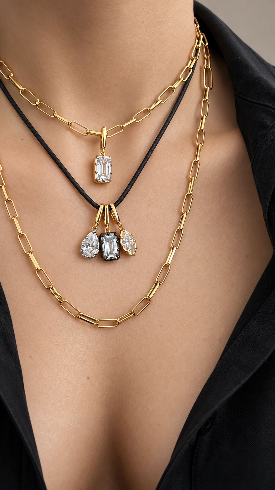 Layered gold necklace look by Galleria Armadoro featuring 35 cm and 45 cm link chains with a black cord and three Vittoria pear, emerald cut and marquise crystal charms.