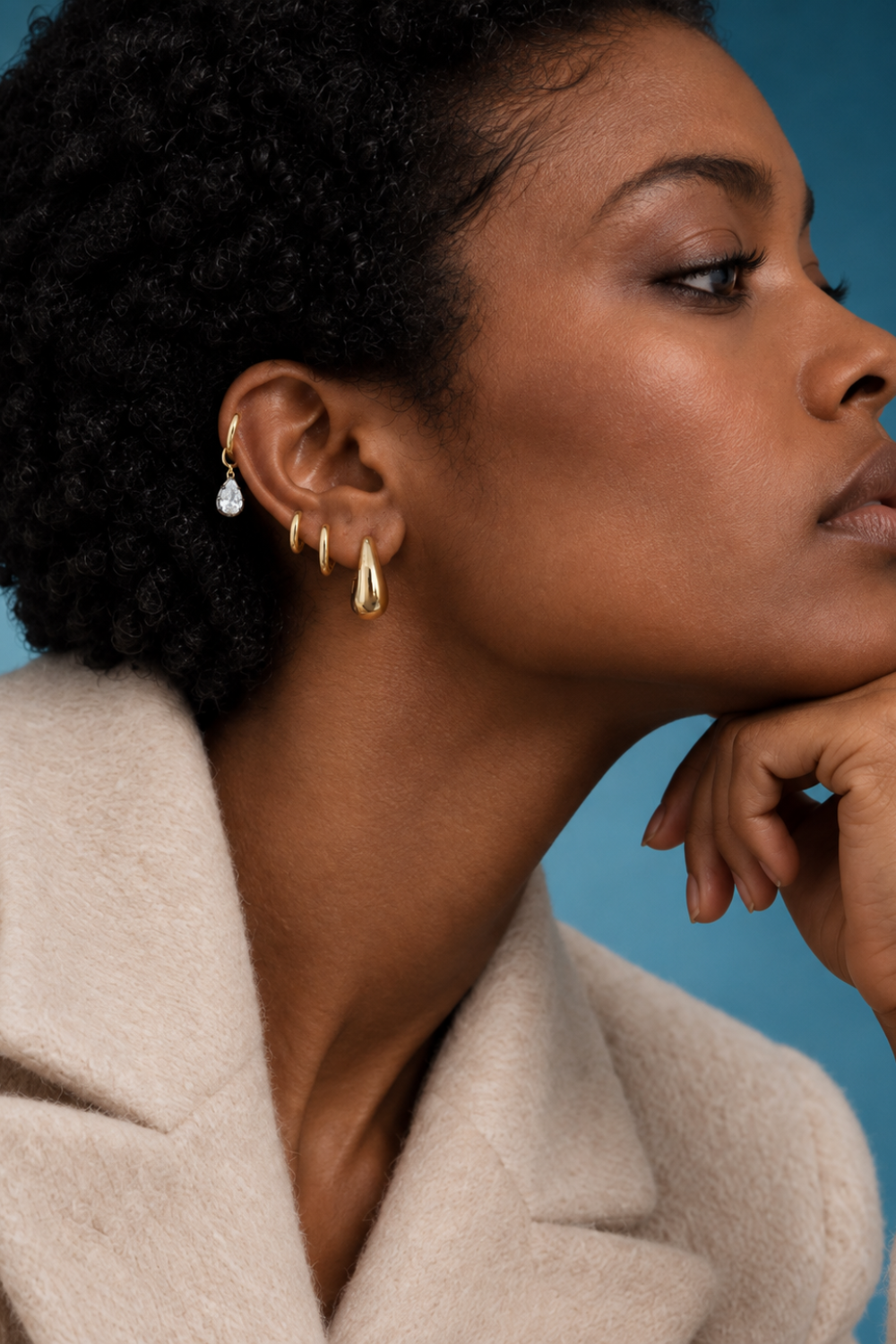 Gold ear stack by Galleria Armadoro featuring Layla at the lobe, smaller gold hoops and a Vittoria teardrop charm styled on the helix.
