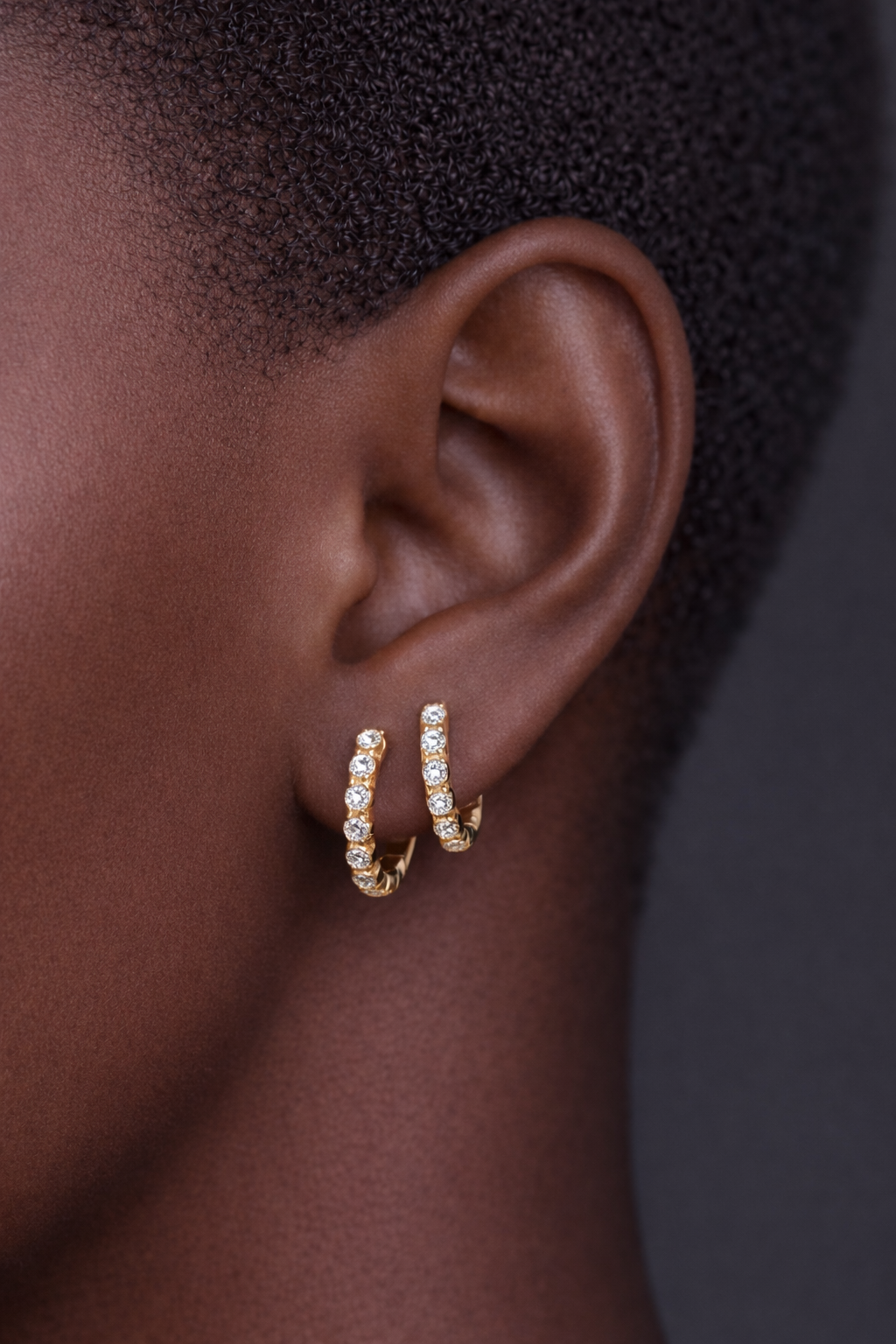 Two earrings in one ear styling with Lola gold vermeil huggies for stacked ear piercings