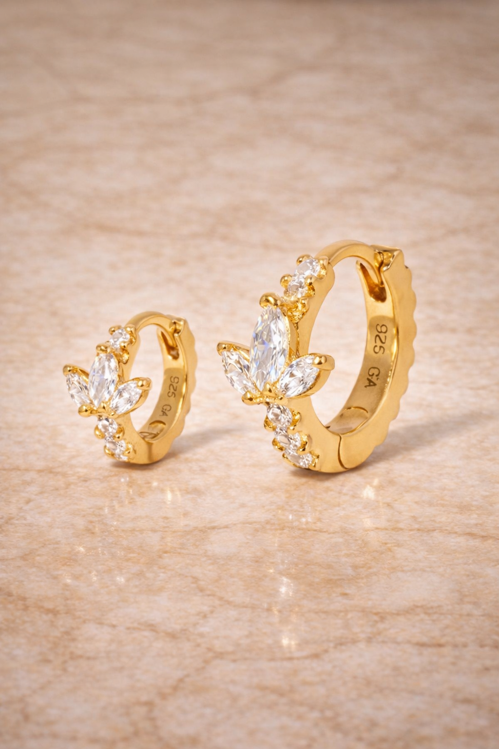 Double ear piercing gold vermeil huggie set with 6.5mm and 8.5mm lotus hoops with white CZ stones