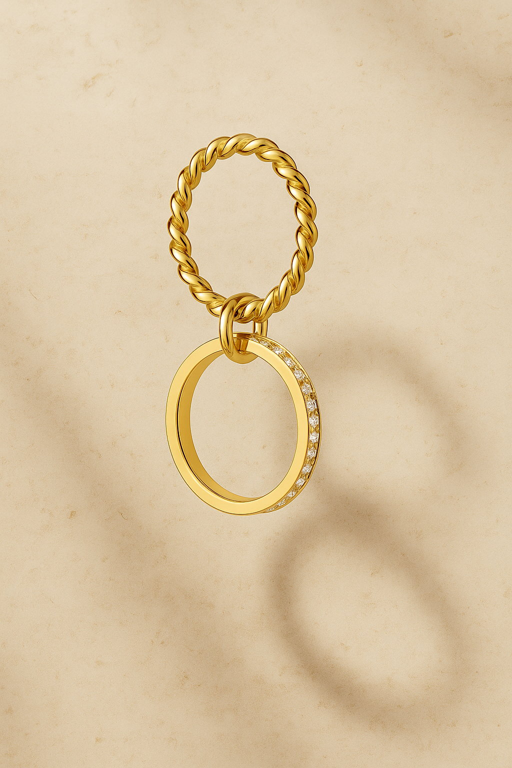 Single Livia double band pavé gold ring worn alone on finger with burgundy nail polish.