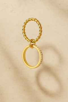 Single Livia double band pavé gold ring worn alone on finger with burgundy nail polish.