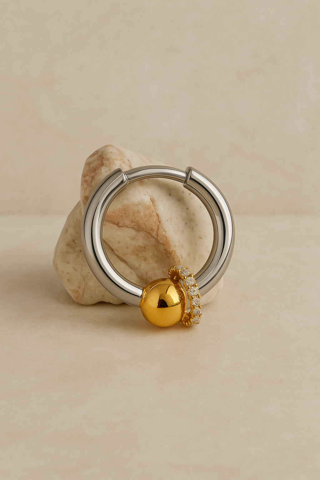 Macro detail of Kora bead huggie with all-around CZ halo and polished gold bead