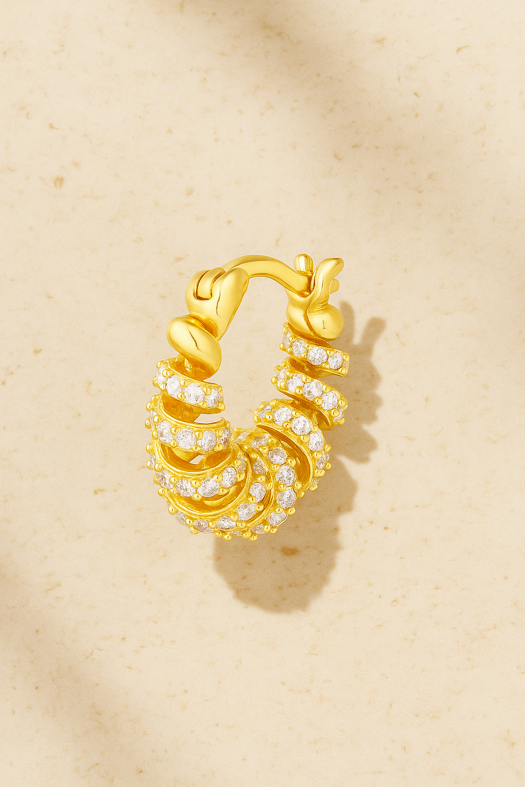 Marielle Gold Huggie Earring with spiral ribbon design and hand-set pavé CZ stones, crafted in 18ct gold-plated sterling silver by Galleria Armadoro.
