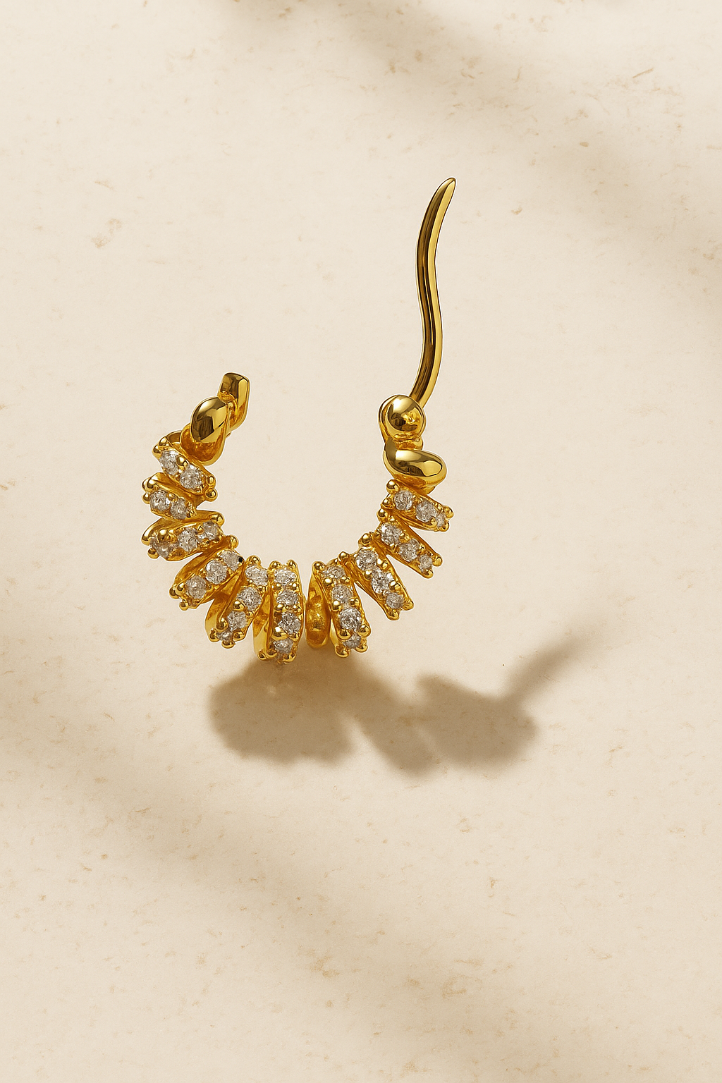 Marielle Gold Huggie Earring open hoop view showing sculptural ribbon silhouette in polished 18ct gold plating and pavé detail.
