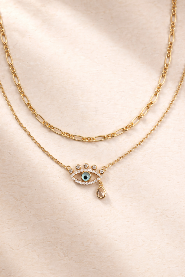 Catalina gold chain layered with evil eye necklace on model