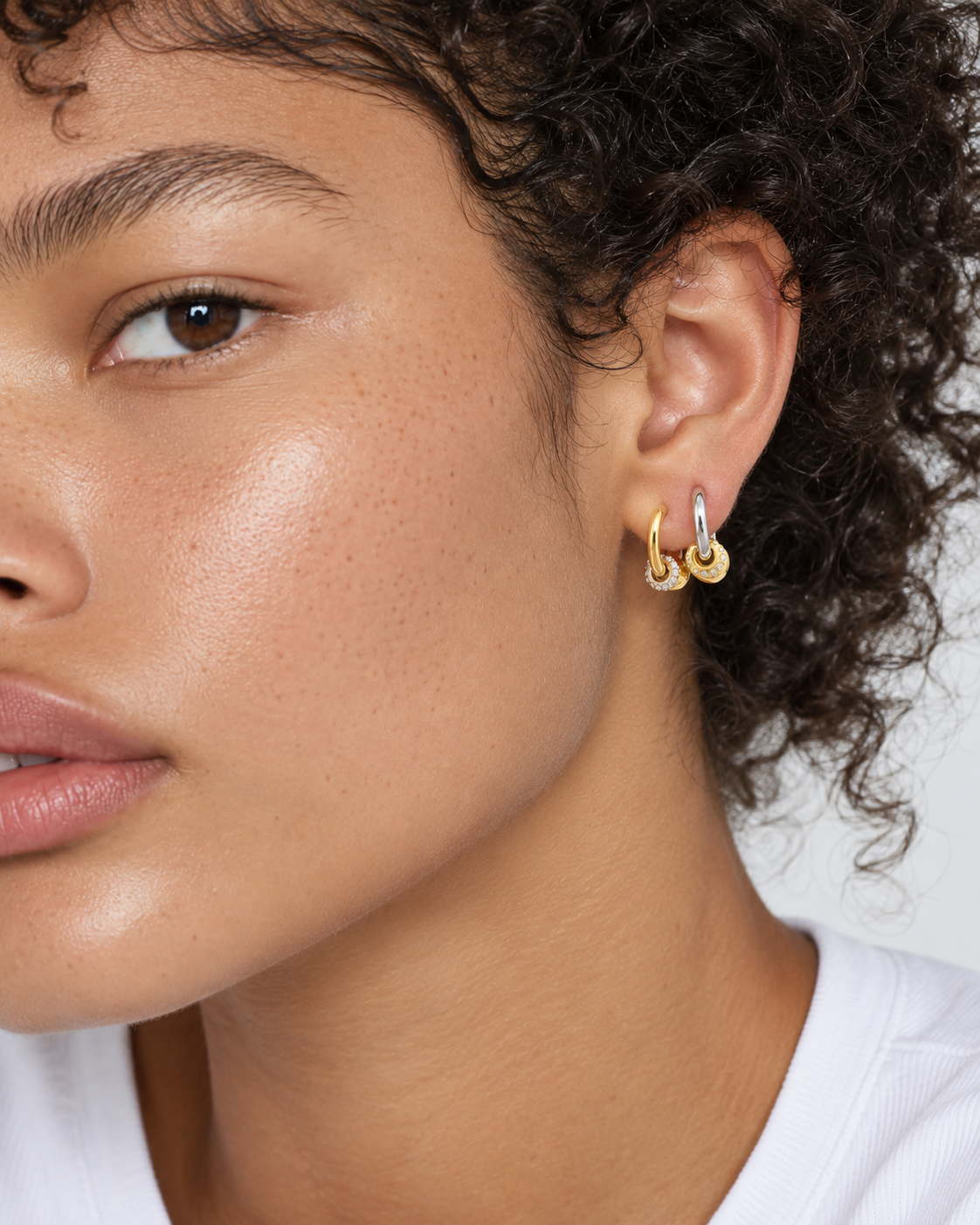 Mixed metal ear stack by Galleria Armadoro featuring Kora huggies in gold and silver for an easy second piercing look.